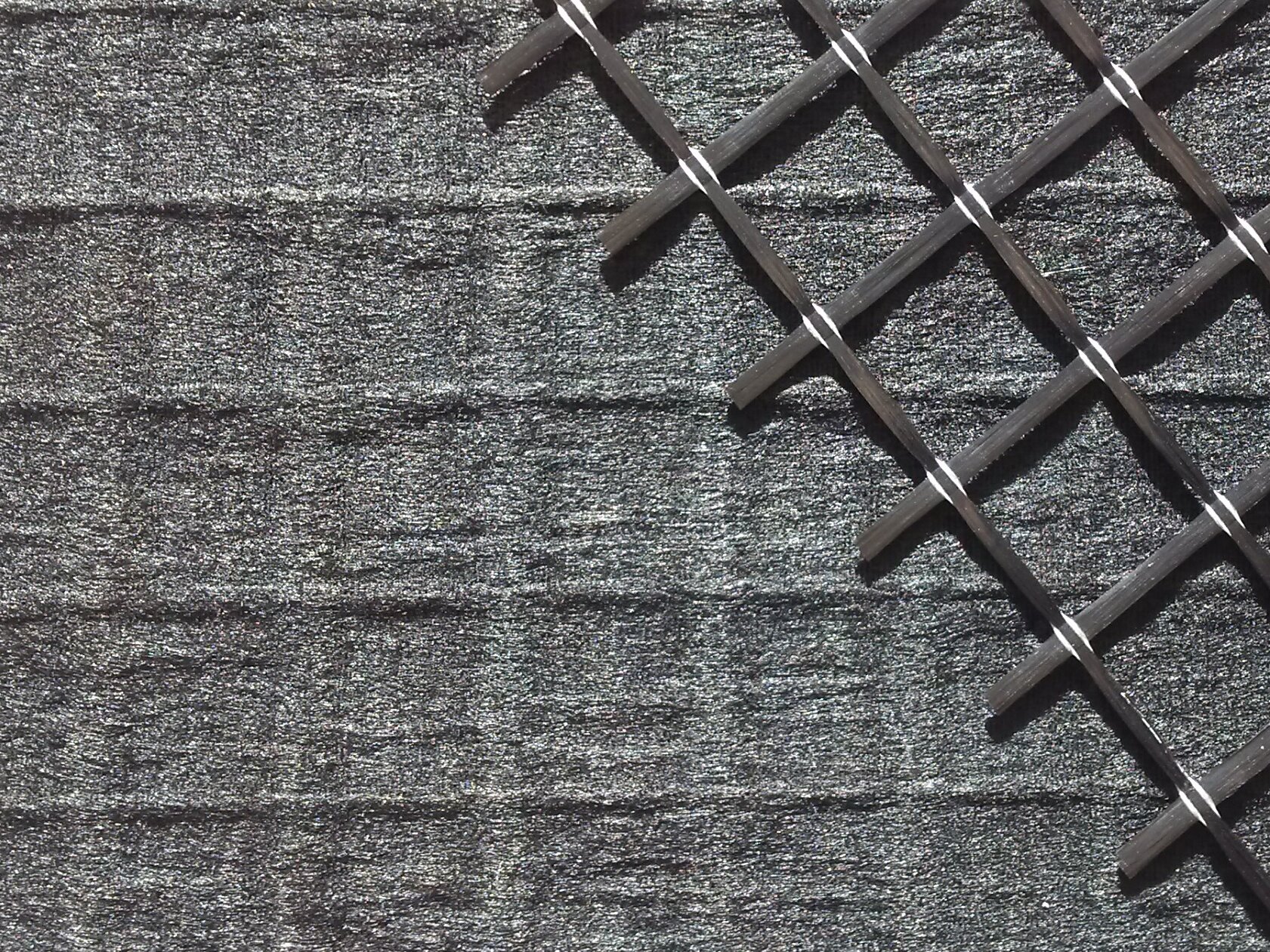Carbon fiber nonwoven reinforced with carbon fiber grid